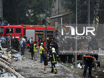 Ukrainian rescuers of emergency services and police officers are working at the site of Okhmatdyt children's hospital damaged by Russian mis...