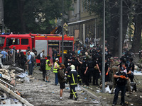 Ukrainian rescuers of emergency services and police officers are working at the site of Okhmatdyt children's hospital damaged by Russian mis...