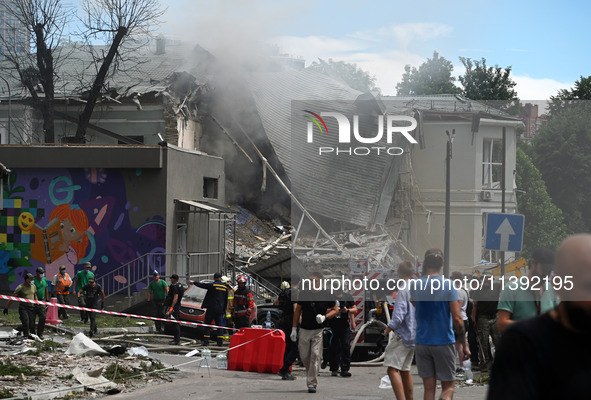 Ukrainian rescuers of emergency services and police officers are working at the site of Okhmatdyt children's hospital damaged by Russian mis...