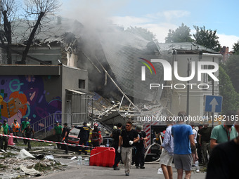 Ukrainian rescuers of emergency services and police officers are working at the site of Okhmatdyt children's hospital damaged by Russian mis...