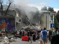 Ukrainian rescuers of emergency services and police officers are working at the site of Okhmatdyt children's hospital damaged by Russian mis...