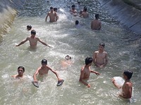 Boys are cooling themselves off on a hot summer day on the outskirts of Srinagar, Kashmir, on July 08, 2024. According to the weather depart...