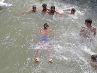 Boys are cooling themselves off on a hot summer day on the outskirts of Srinagar, Kashmir, on July 08, 2024. According to the weather depart...