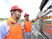 Workers are inspecting water supply equipment in Chaohu, China, on July 8, 2024. (