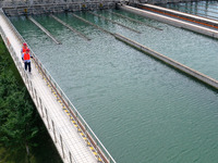 Workers are inspecting a reaction sedimentation tank at a water plant in Chaohu city, Anhui province, China, on July 8, 2024. (