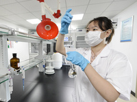 A worker is testing the water quality in Chaohu, China, on July 8, 2024. (