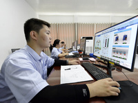 Workers are monitoring the operation of water supply equipment in the central control room of a water plant in Chaohu, China, on July 8, 202...