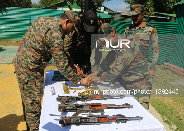 Arms and ammunition are being recovered from militants in twin encounters and are being displayed at an army base in Anantnag, south of Srin...