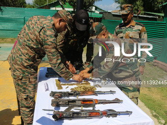 Arms and ammunition are being recovered from militants in twin encounters and are being displayed at an army base in Anantnag, south of Srin...