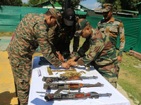 Arms and ammunition are being recovered from militants in twin encounters and are being displayed at an army base in Anantnag, south of Srin...