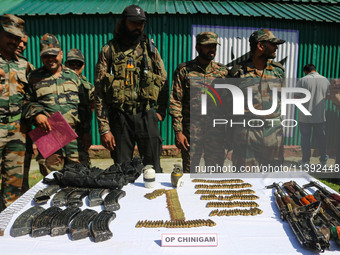 Arms and ammunition are being recovered from militants in twin encounters and are being displayed at an army base in Anantnag, south of Srin...