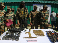 Arms and ammunition are being recovered from militants in twin encounters and are being displayed at an army base in Anantnag, south of Srin...