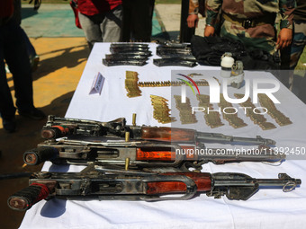 Arms and ammunition are being recovered from militants in twin encounters and are being displayed at an army base in Anantnag, south of Srin...