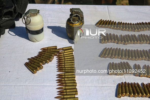 Arms and ammunition are being recovered from militants in twin encounters and are being displayed at an army base in Anantnag, south of Srin...