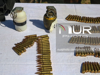 Arms and ammunition are being recovered from militants in twin encounters and are being displayed at an army base in Anantnag, south of Srin...