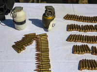 Arms and ammunition are being recovered from militants in twin encounters and are being displayed at an army base in Anantnag, south of Srin...