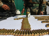 Arms and ammunition are being recovered from militants in twin encounters and are being displayed at an army base in Anantnag, south of Srin...