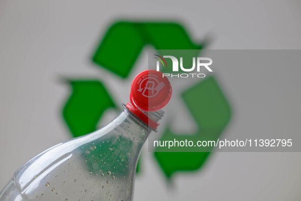 A plastic soda bottle with an attached cap (tethered cap) is being shown as per new EU regulations in Brussels, Belgium, on July 8, 2024. 