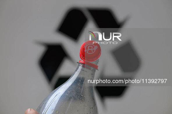 A plastic soda bottle with an attached cap (tethered cap) is being shown as per new EU regulations in Brussels, Belgium, on July 8, 2024. 