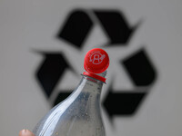 A plastic soda bottle with an attached cap (tethered cap) is being shown as per new EU regulations in Brussels, Belgium, on July 8, 2024. (