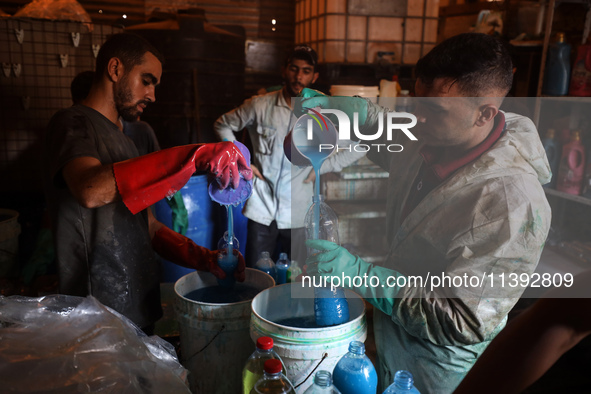 Palestinian manufacturers are bottling locally-made cleaning products in Deir el-Balah in the central Gaza Strip on July 8, 2024, amid a lac...