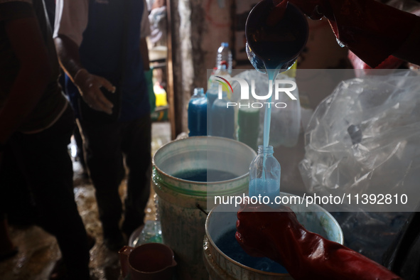 Palestinian manufacturers are bottling locally-made cleaning products in Deir el-Balah in the central Gaza Strip on July 8, 2024, amid a lac...