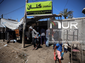 Palestinian manufacturers are bottling locally-made cleaning products in Deir el-Balah in the central Gaza Strip on July 8, 2024, amid a lac...