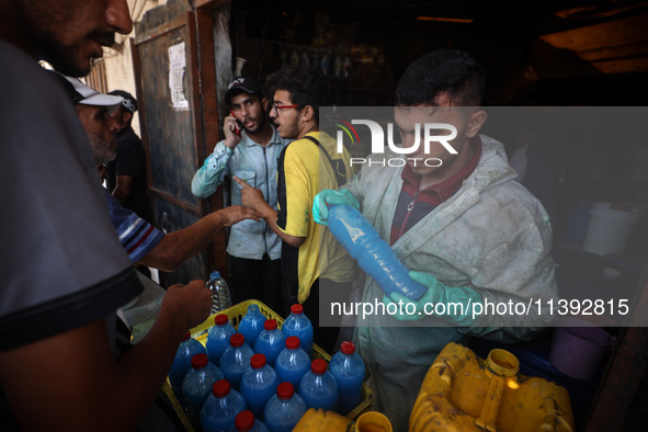 Palestinian manufacturers are bottling locally-made cleaning products in Deir el-Balah in the central Gaza Strip on July 8, 2024, amid a lac...