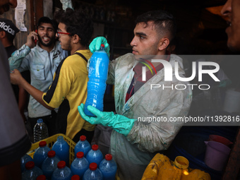 Palestinian manufacturers are bottling locally-made cleaning products in Deir el-Balah in the central Gaza Strip on July 8, 2024, amid a lac...