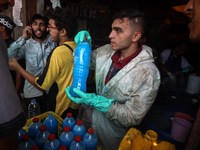 Palestinian manufacturers are bottling locally-made cleaning products in Deir el-Balah in the central Gaza Strip on July 8, 2024, amid a lac...