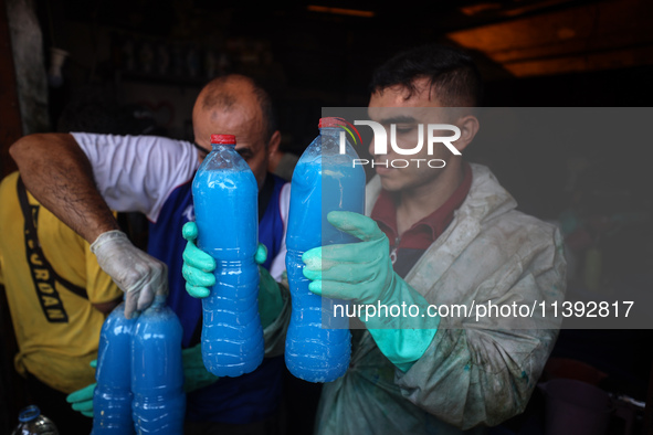 Palestinian manufacturers are bottling locally-made cleaning products in Deir el-Balah in the central Gaza Strip on July 8, 2024, amid a lac...