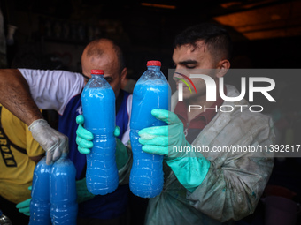 Palestinian manufacturers are bottling locally-made cleaning products in Deir el-Balah in the central Gaza Strip on July 8, 2024, amid a lac...