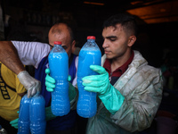 Palestinian manufacturers are bottling locally-made cleaning products in Deir el-Balah in the central Gaza Strip on July 8, 2024, amid a lac...