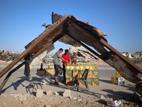 Palestinians are walking past cooking oil for sale along Salah al-Din Street in Deir el-Balah in the central Gaza Strip, on July 8, 2024, am...