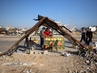 Palestinians are walking past cooking oil for sale along Salah al-Din Street in Deir el-Balah in the central Gaza Strip, on July 8, 2024, am...