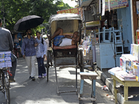 A rickshaw puller is relaxing on his rickshaw during the afternoon, in North Kolkata, India, on July 8, 2024. (