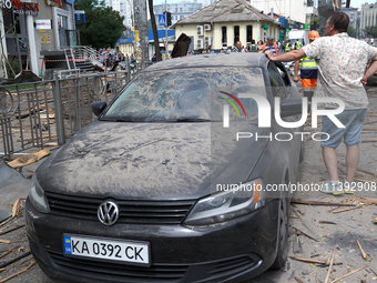 A man is leaning on a car parked near the Lukianivska metro station during a Russian missile attack in Kyiv, Ukraine, on July 8, 2024. NO US...