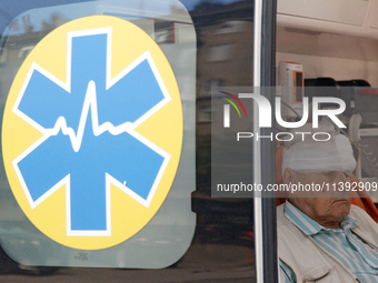 An elderly man with a bandaged head injured during a Russian missile attack is sitting in an ambulance in Kyiv, Ukraine, on July 8, 2024. NO...