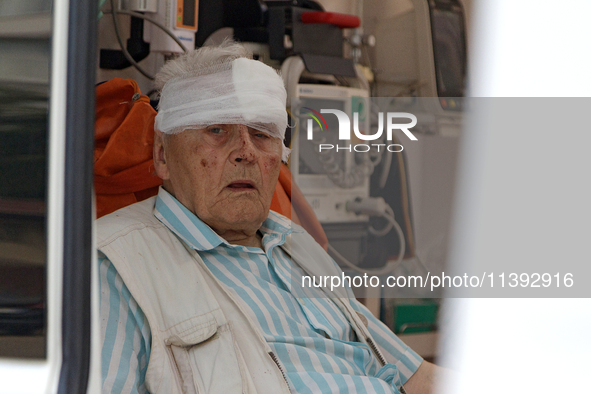 An elderly man with a bandaged head injured during a Russian missile attack is sitting in an ambulance in Kyiv, Ukraine, on July 8, 2024. NO...