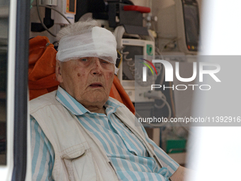 An elderly man with a bandaged head injured during a Russian missile attack is sitting in an ambulance in Kyiv, Ukraine, on July 8, 2024. NO...