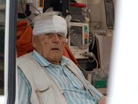 An elderly man with a bandaged head injured during a Russian missile attack is sitting in an ambulance in Kyiv, Ukraine, on July 8, 2024. NO...