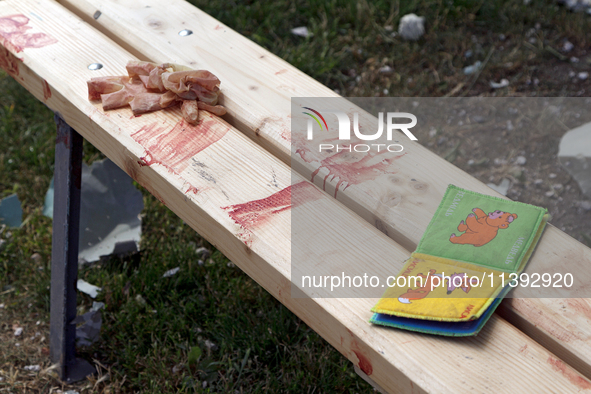 A children's book is lying on the blood-stained bench in the Shevchenkivskyi district during a Russian missile attack in Kyiv, Ukraine, on J...