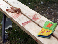 A children's book is lying on the blood-stained bench in the Shevchenkivskyi district during a Russian missile attack in Kyiv, Ukraine, on J...