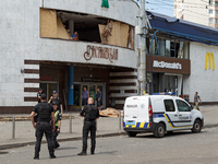 Police officers are standing outside the Lukianivska metro station damaged during a Russian missile attack in Kyiv, Ukraine, on July 8, 2024...