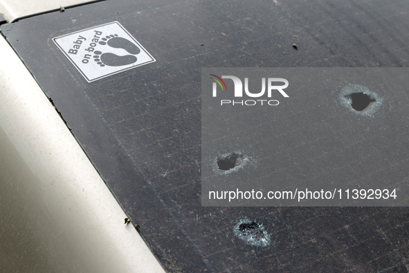 Holes are appearing in the rear window of a car with the sticker 'Baby on Board' in the Shevchenkivskyi district during a Russian missile at...