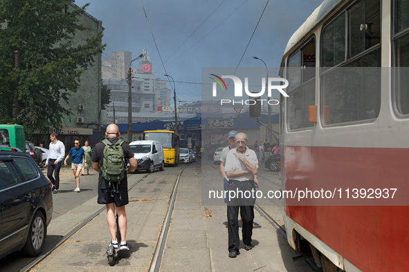 People are staying near the Lukianivska metro station as smoke is covering the surroundings as a result of a Russian missile attack in Kyiv,...