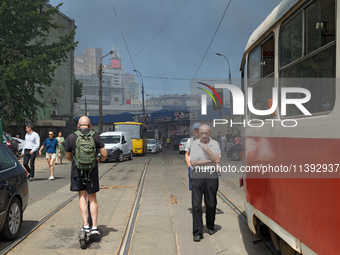 People are staying near the Lukianivska metro station as smoke is covering the surroundings as a result of a Russian missile attack in Kyiv,...