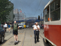 People are staying near the Lukianivska metro station as smoke is covering the surroundings as a result of a Russian missile attack in Kyiv,...