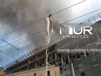 The roof of an unfinished building is catching fire near the Lukianivska metro station as a result of a Russian missile attack in Kyiv, Ukra...