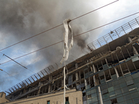 The roof of an unfinished building is catching fire near the Lukianivska metro station as a result of a Russian missile attack in Kyiv, Ukra...